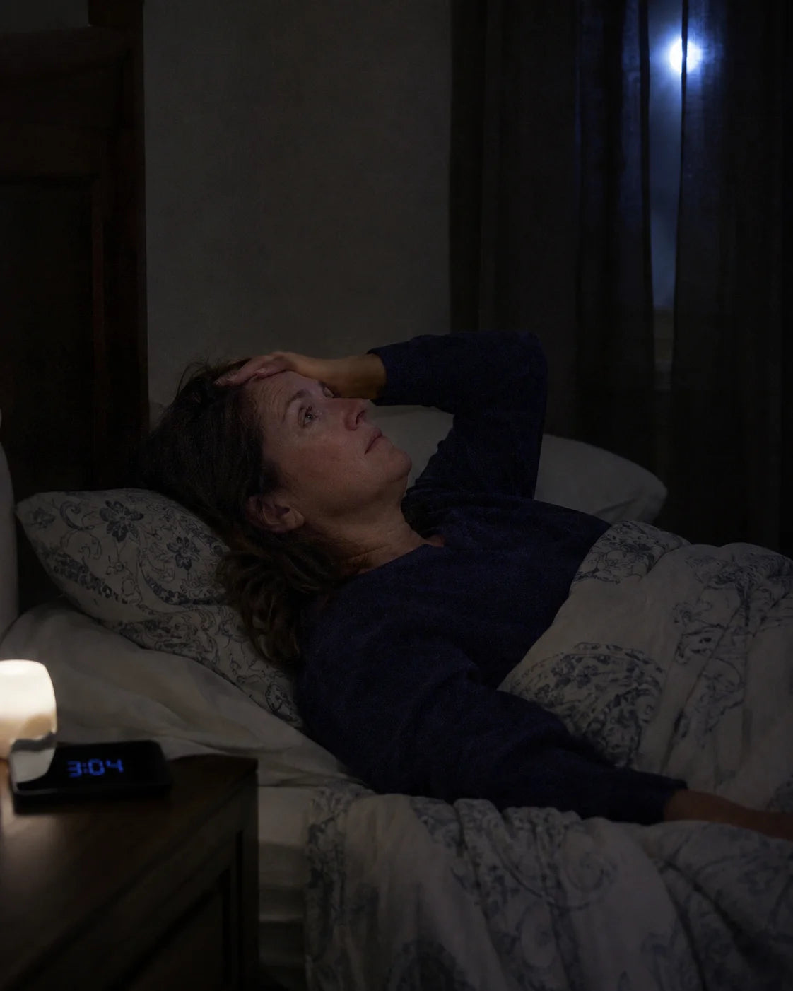 Woman lying awake in bed at 3am